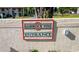 Hammock Pine entrance sign with lush landscaping providing a warm welcome to the community at 2213 Hammock Pine Blvd, Clearwater, FL 33761
