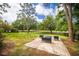 Outdoor seating area on brick patio featuring serene golf course views, perfect for relaxing and entertaining at 2220 Muirfield Way, Oldsmar, FL 34677