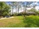 Spacious backyard with a paver patio and comfortable seating, set against a backdrop of lush landscaping at 2220 Muirfield Way, Oldsmar, FL 34677