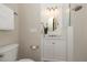 Modern bathroom featuring a white vanity with marble countertop and a glass-enclosed shower at 2220 Muirfield Way, Oldsmar, FL 34677