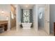 Bright bathroom showcasing a stylish soaking tub, large shower, and granite vanity at 2220 Muirfield Way, Oldsmar, FL 34677