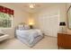 Serene bedroom with soft carpet, neutral walls, and a large window and closet space at 2220 Muirfield Way, Oldsmar, FL 34677