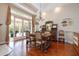 Elegant dining room with a chandelier, antique furniture, and access to the outdoor patio at 2220 Muirfield Way, Oldsmar, FL 34677