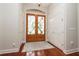 Elegant entryway featuring decorative glass double doors and gleaming hardwood floors at 2220 Muirfield Way, Oldsmar, FL 34677