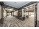 Elegant hallway with grey trim and display cases, leading to a room with tables and chairs at 2220 Muirfield Way, Oldsmar, FL 34677