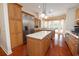 Spacious kitchen with stainless steel appliances, center island, and a bay window overlooking the backyard at 2220 Muirfield Way, Oldsmar, FL 34677