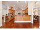 Open kitchen with island and bar seating, connected to casual dining and living areas at 2220 Muirfield Way, Oldsmar, FL 34677