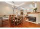 Open-concept living area with a fireplace, dining table, and elegant double door entryway at 2220 Muirfield Way, Oldsmar, FL 34677