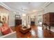 Cozy living room with fireplace, hardwood floors, and access to the lanai at 2220 Muirfield Way, Oldsmar, FL 34677