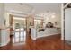 Bright living room with hardwood floors, fireplace, and sliding glass doors to outdoor patio at 2220 Muirfield Way, Oldsmar, FL 34677