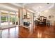 Spacious living area connecting to the dining room, featuring a fireplace and sliding glass doors at 2220 Muirfield Way, Oldsmar, FL 34677