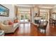 Beautiful living room featuring hardwood floors, a cozy fireplace, and scenic backyard views at 2220 Muirfield Way, Oldsmar, FL 34677