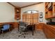 Cozy home office featuring custom built-ins and shelving, plus a large window for natural light at 2220 Muirfield Way, Oldsmar, FL 34677