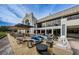 Inviting outdoor patio with comfortable seating, fire pits, and views of a building with large windows at 2220 Muirfield Way, Oldsmar, FL 34677