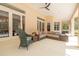 Enjoy the outdoor living space of this covered patio with ample seating and lots of natural light at 2220 Muirfield Way, Oldsmar, FL 34677