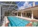 The clear blue swimming pool is fully screened in for endless days of outdoor fun at 2220 Muirfield Way, Oldsmar, FL 34677
