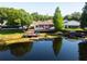 Aerial view of back of house showing deck, dock, and lake. Plenty of greenery and privacy at 2347 Foggy Ridge Pkwy, Land O Lakes, FL 34639