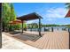 Open backyard deck with beautiful lake view and shade umbrella at 2347 Foggy Ridge Pkwy, Land O Lakes, FL 34639