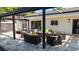 Cozy backyard patio with comfortable seating, ideal for outdoor entertaining with a covered pergola and hot tub at 2347 Foggy Ridge Pkwy, Land O Lakes, FL 34639