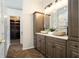 Stylish bathroom featuring dual stone vessel sinks and decorative herringbone floors at 2347 Foggy Ridge Pkwy, Land O Lakes, FL 34639