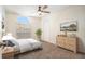 Cozy bedroom with large window, ceiling fan, and carpet flooring at 2347 Foggy Ridge Pkwy, Land O Lakes, FL 34639