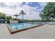 Community pool with clear blue water and ample lounge seating, perfect for relaxation and enjoying the outdoors at 2347 Foggy Ridge Pkwy, Land O Lakes, FL 34639