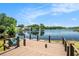 Enjoy the view from this waterfront home's wooden deck, complete with chairs and serene lake scenery at 2347 Foggy Ridge Pkwy, Land O Lakes, FL 34639
