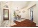 Inviting foyer with hardwood floors, decorative door, and elegant light fixture at 2347 Foggy Ridge Pkwy, Land O Lakes, FL 34639