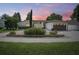 Charming one-story home with a manicured front yard and a brick driveway at sunset at 2347 Foggy Ridge Pkwy, Land O Lakes, FL 34639