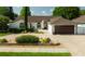 Charming one-story home with a well-manicured front yard, brick driveway, and attached garage at 2347 Foggy Ridge Pkwy, Land O Lakes, FL 34639