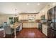 Eat-in kitchen featuring stainless steel appliances, white cabinets, and wood floors at 2347 Foggy Ridge Pkwy, Land O Lakes, FL 34639