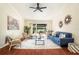 Cozy living room boasts hardwood floors, comfortable seating, and sliding doors to the outdoor patio at 2347 Foggy Ridge Pkwy, Land O Lakes, FL 34639