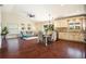 Open floor plan with wood floors connects the living room to the eat-in kitchen and breakfast bar at 2347 Foggy Ridge Pkwy, Land O Lakes, FL 34639