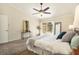 Spacious main bedroom with neutral colors, a ceiling fan, and a view of the outdoor patio at 2347 Foggy Ridge Pkwy, Land O Lakes, FL 34639