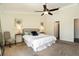 Main bedroom featuring a ceiling fan, carpet flooring, and access to the main bathroom at 2347 Foggy Ridge Pkwy, Land O Lakes, FL 34639
