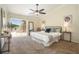 Bright main bedroom with ceiling fan, water view access, and neutral decor at 2347 Foggy Ridge Pkwy, Land O Lakes, FL 34639