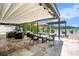 Expansive outdoor patio with stylish seating, a retractable awning, and beautiful waterfront views at 2347 Foggy Ridge Pkwy, Land O Lakes, FL 34639