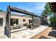 Outdoor living area features travertine tile and a retractable awning at 2347 Foggy Ridge Pkwy, Land O Lakes, FL 34639