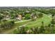 Scenic aerial view of a home situated on a golf course with lush greenery and mature trees at 2616 Fairway S Ave, St Petersburg, FL 33712