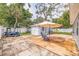 Backyard featuring a patio with chairs, an umbrella, a shed, and a golf cart at 2616 Fairway S Ave, St Petersburg, FL 33712
