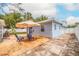 Backyard patio featuring a set of chairs and an umbrella, great for relaxing or entertaining at 2616 Fairway S Ave, St Petersburg, FL 33712