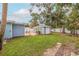 Lush backyard features a charming shed and patio seating, perfect for relaxation and outdoor entertaining at 2616 Fairway S Ave, St Petersburg, FL 33712