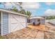 Backyard featuring a shed, and a patio with an umbrella and chairs at 2616 Fairway S Ave, St Petersburg, FL 33712