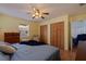 Bright bedroom featuring a large window, a ceiling fan, and a closet for convenient storage at 2616 Fairway S Ave, St Petersburg, FL 33712
