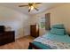 Bright bedroom featuring a large window, a ceiling fan, and a closet for convenient storage at 2616 Fairway S Ave, St Petersburg, FL 33712