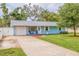 Charming home featuring a well-manicured lawn and driveway leading to the attached garage at 2616 Fairway S Ave, St Petersburg, FL 33712