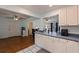 Bright kitchen with white cabinets, stainless appliances, and an eat-in bar leading to the adjacent living space at 2616 Fairway S Ave, St Petersburg, FL 33712