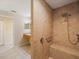 Tiled roll-in shower with a built-in seat and grab bar for accessibility and safety at 2673 Clubhouse S Dr, Clearwater, FL 33761