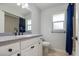 Bathroom featuring a vanity, toilet, and shower/tub combination with blue curtains at 2673 Clubhouse S Dr, Clearwater, FL 33761