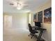 Spacious bedroom featuring neutral carpet, a ceiling fan, and gaming-themed decor at 2673 Clubhouse S Dr, Clearwater, FL 33761